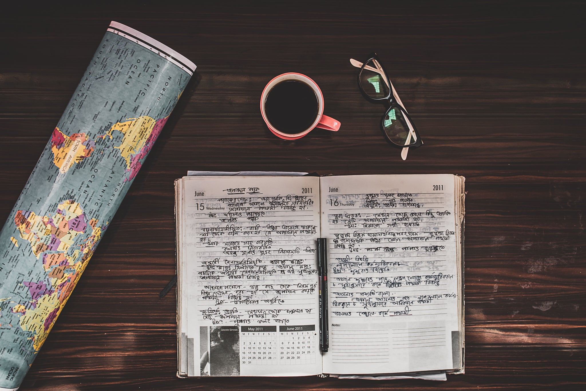 World Map with coffee mug and travel journal on desk